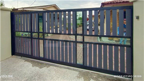 Mild steel sliding gate with aluminium panels and tempered glass
